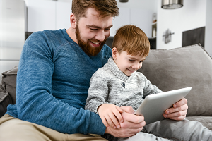 male parent reading to his child.